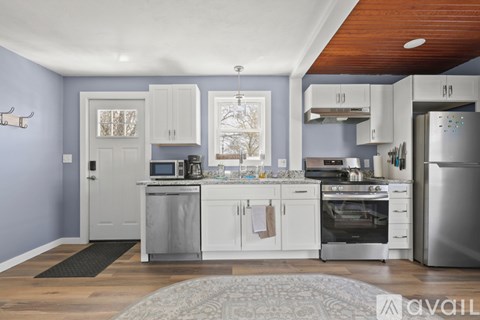 A kitchen with white cabinets and stainless steel appliances.