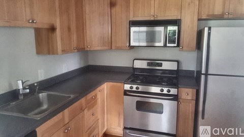 A kitchen with wooden cabinets and stainless steel appliances.