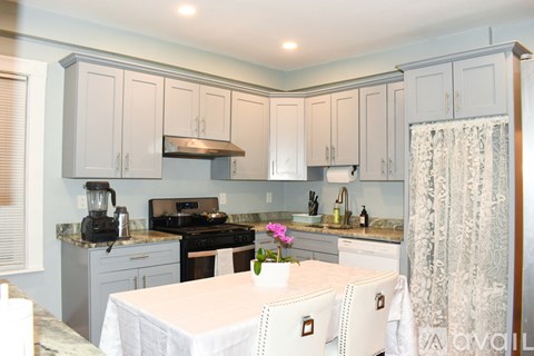 A kitchen with a table set for two.