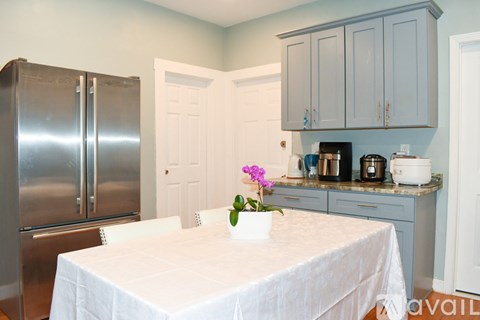 A kitchen with a table set for two.