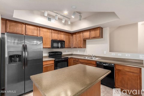 A kitchen with wooden cabinets and stainless steel appliances.