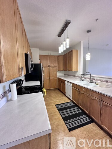 A kitchen with wooden cabinets and a white countertop.