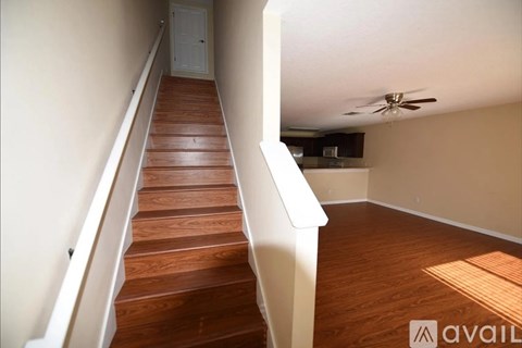 A long flight of wooden stairs leads to a door.
