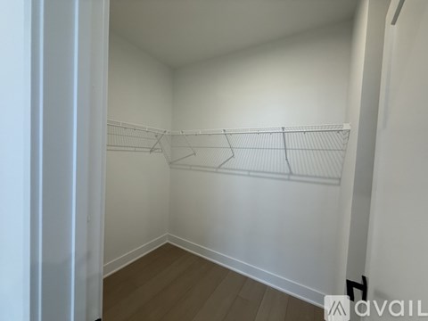 Empty room with white walls and wooden floor.