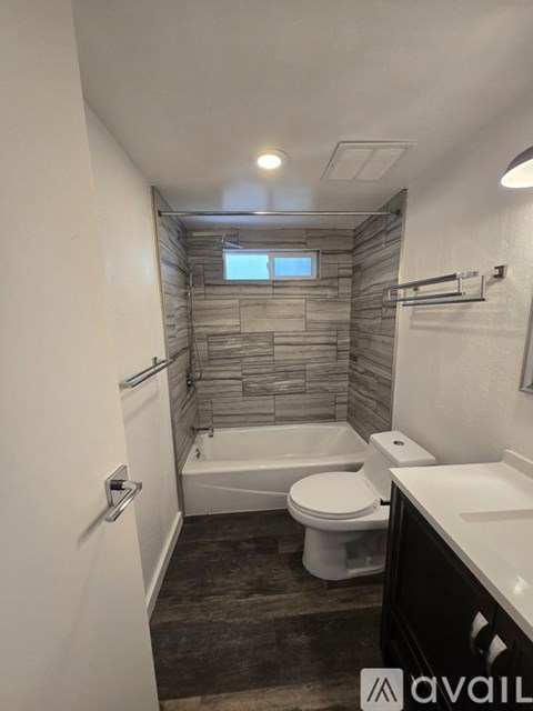 A bathroom with a toilet, sink, and a walk-in shower.