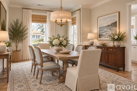 A dining room with a large table and chairs.