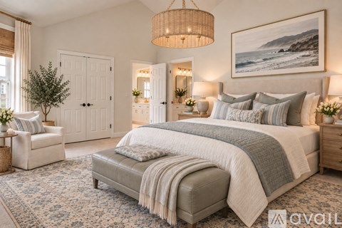A bedroom with a large bed, a chair, and a painting on the wall.