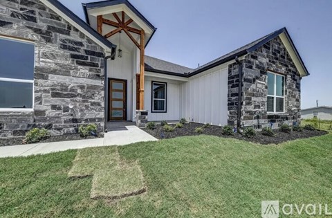 A house with a stone exterior and a wooden door is for sale.