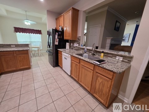 A kitchen with wooden cabinets and a granite countertop.