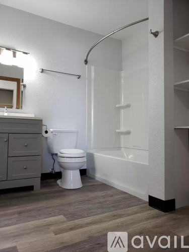A bathroom with a toilet, a sink, and a bathtub.