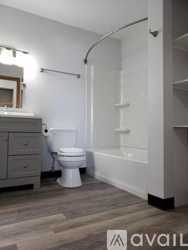 A bathroom with a toilet, a sink, and a bathtub.