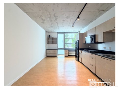 A kitchen with white cabinets and a black countertop.