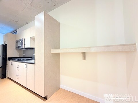 A kitchen area with a microwave and a counter.