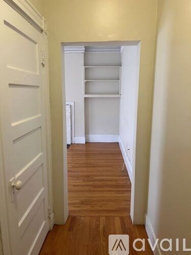 A white door is on the left and an open white doorway is on the right.