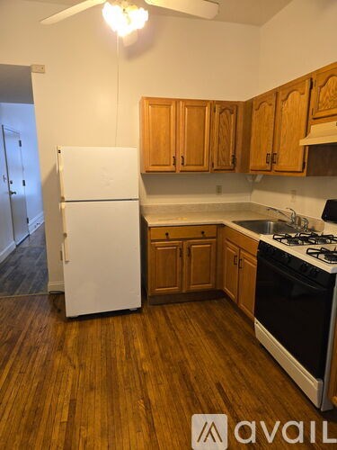 A kitchen with a white fridge and black stove.