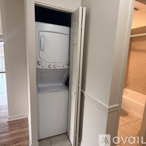 A white dishwasher is built into a wall.