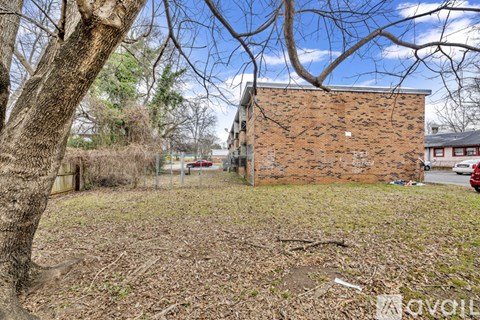A brick building with a tree in front of it.