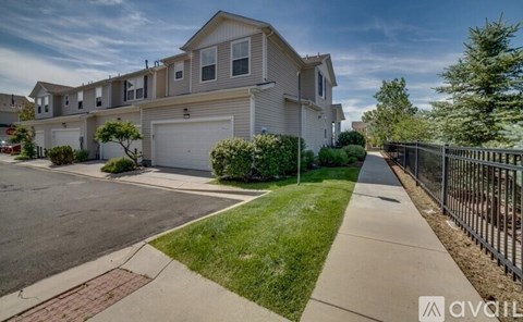 A row of houses with a sidewalk in front.