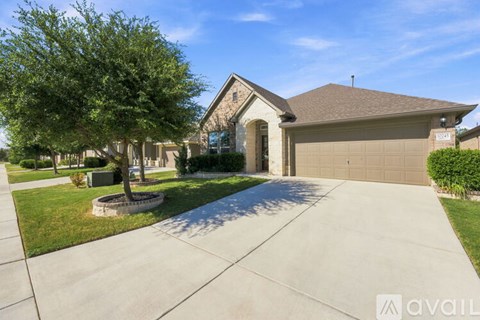 A house with a garage and a driveway is available for sale.