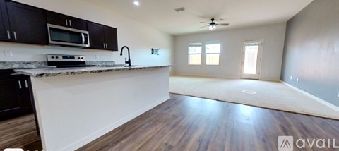 A kitchen with dark wood cabinets and a white countertop.
