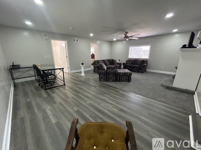 A living room with a grey floor and a white ceiling.