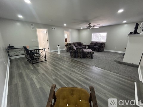 A living room with a grey floor and a white ceiling.