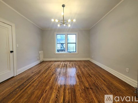 A room with wooden floors and a window.