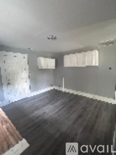 A room with wooden floors and white walls.