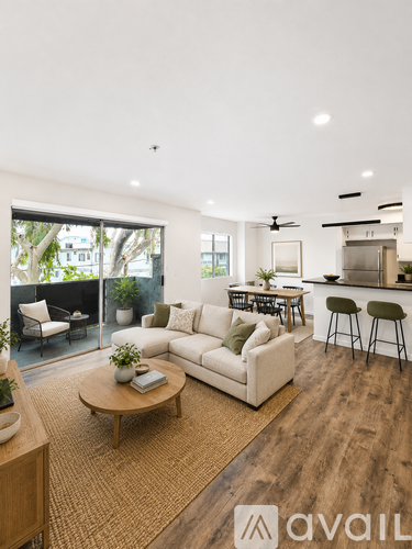 A living room with a white sofa and a wooden coffee table.