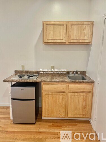 A kitchen with wooden cabinets and a granite countertop.