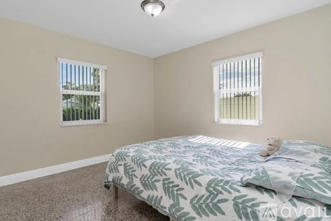 A bedroom with a bed and a teddy bear on it.