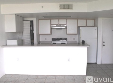 A kitchen with white appliances and cabinets.