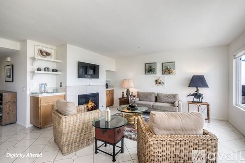 A living room with a fireplace, couches, and a coffee table.