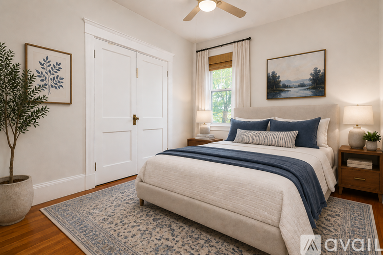 A bedroom with a large bed and a ceiling fan.