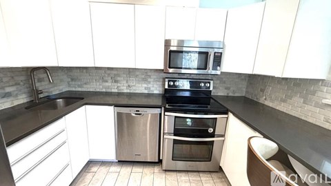 A kitchen with a stainless steel oven and microwave.