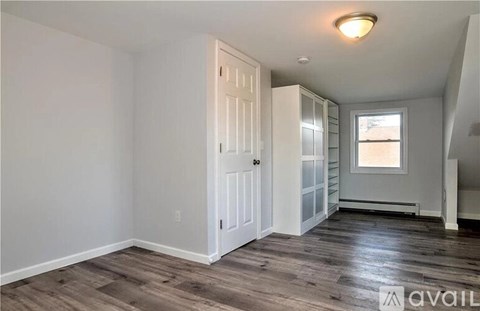 A room with a wooden floor and white walls.