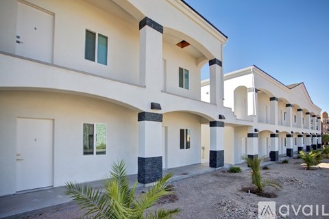 A row of white houses with black trim and windows.