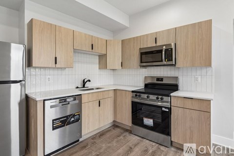 A kitchen with wooden cabinets and stainless steel appliances.