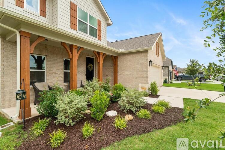 A house with a front yard and landscaping.
