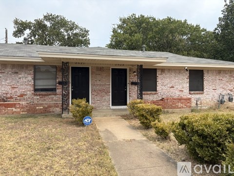 A house with a black door and windows is for sale.