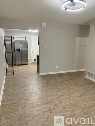 A room with a wooden floor and a ceiling fan.
