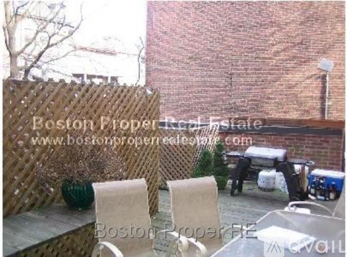 A patio with two chairs and a table is shown in the image.