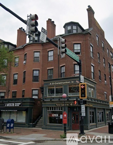 A street corner with a traffic light and a building with a sign that says Adconstruction Inc.