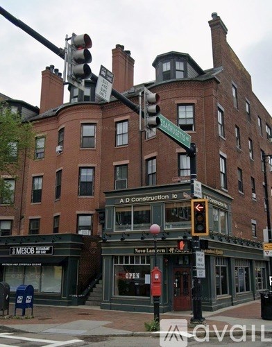 A street corner with a traffic light and a building with a sign that says Adconstruction Inc.