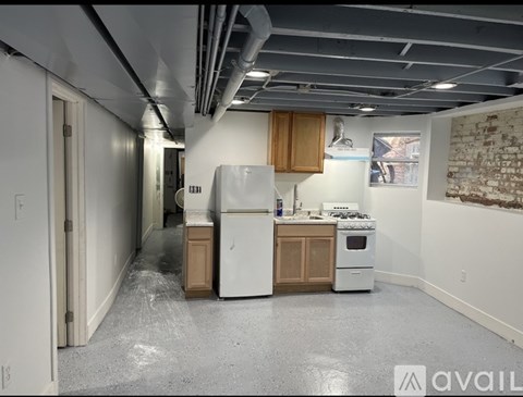 A kitchen with a white fridge, stove, and oven.