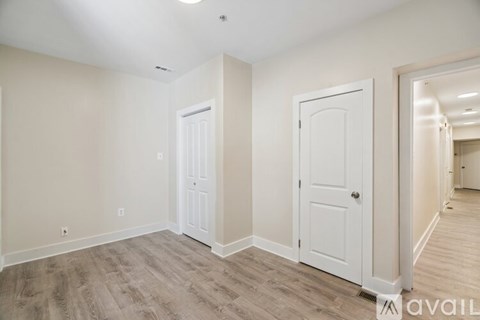 A room with two doors and a hallway.