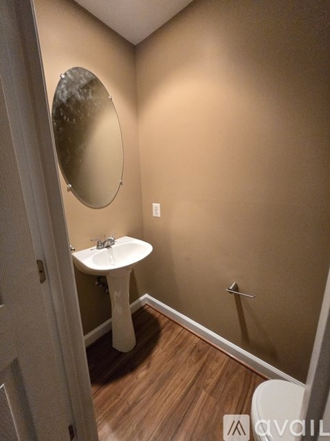 A bathroom with a sink, mirror and toilet.