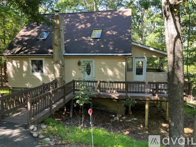 A small house with a porch and a deck.