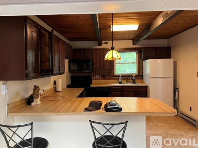 A kitchen with wooden cabinets and a white refrigerator.