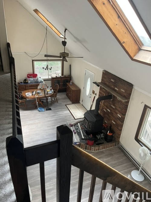 A room with a wooden floor and a ceiling fan.
